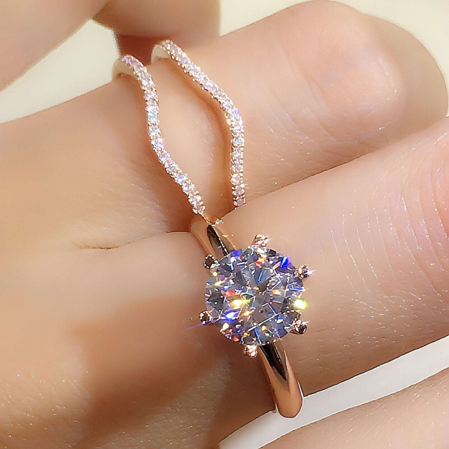 Pair of 18K gold moissanite rings by Carmine Juneberry showcasing elegant design and sparkling gemstone accents.