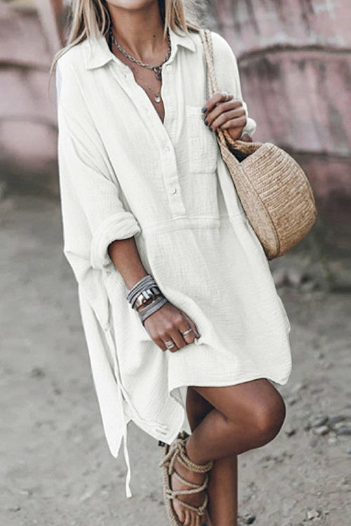 Light beige linen mini dress for women with half-button front and pocket details by Jade, casual and comfortable for everyday wear.