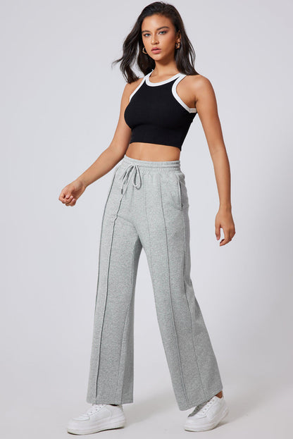 Gray seamed high waist wide leg sweatpants by Carmine Juneberry with drawstring detail and comfortable fit.