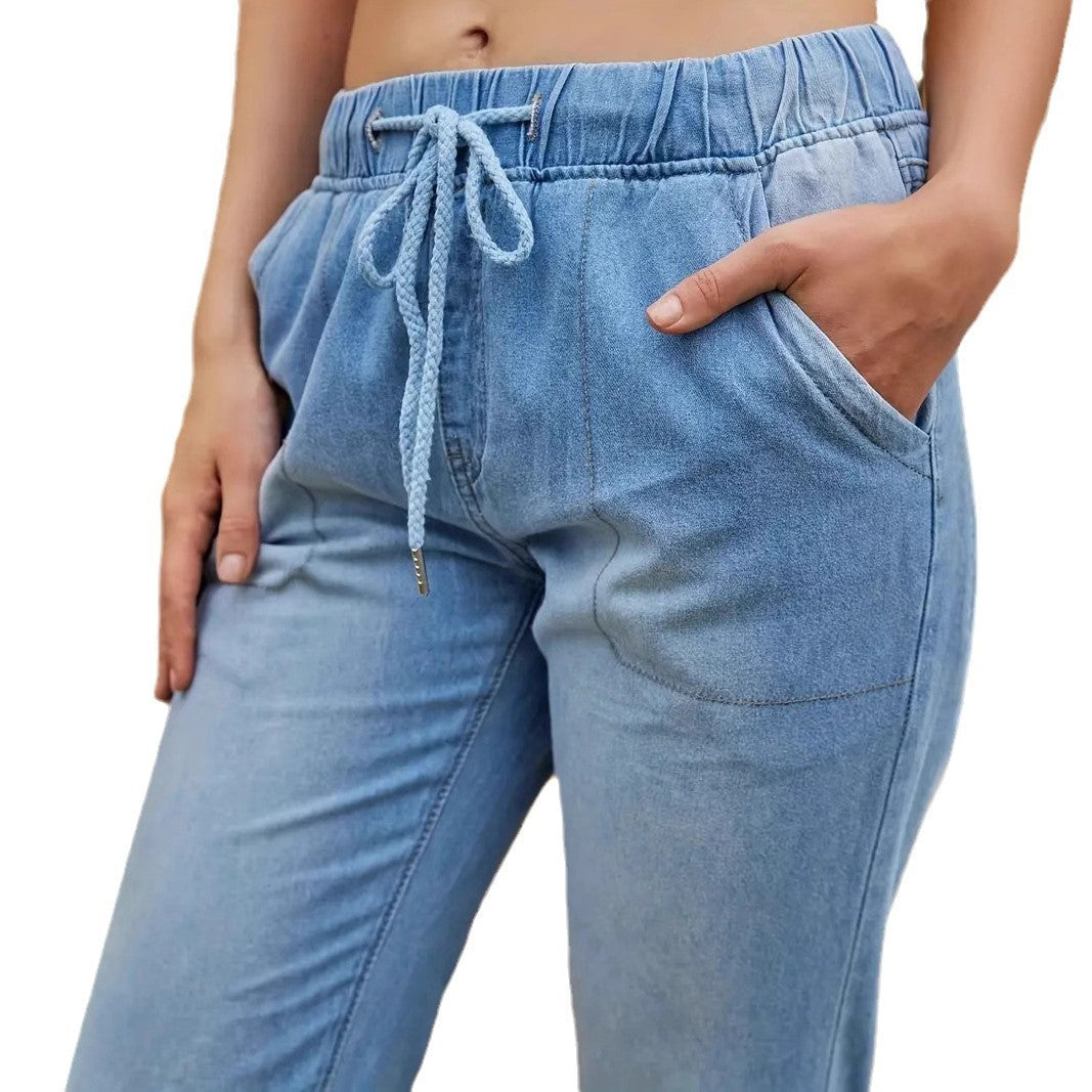 Korean-inspired high waist skinny jeans with elastic waistband by Carmine Juneberry, shown in a close-up view of the denim fabric.