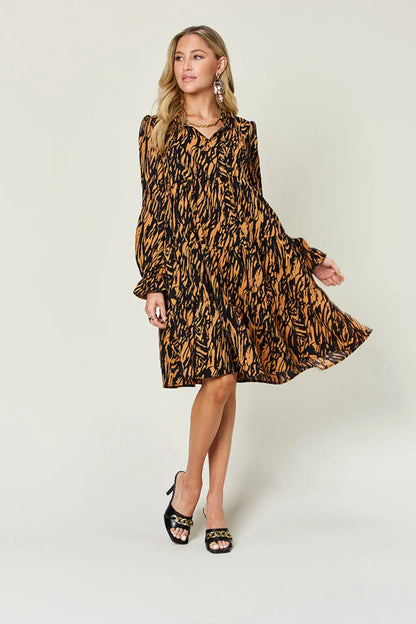 Pear Daisy double take full size printed ruffle hem long sleeve dress, showcasing a stylish floral pattern and ruffle details.