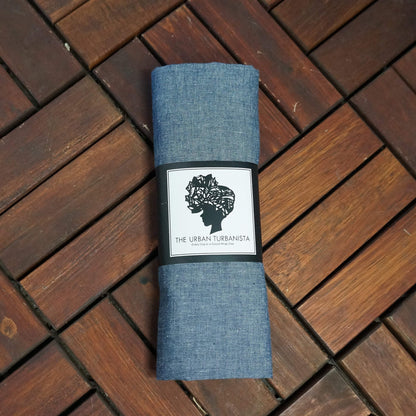 Denim chambray headwrap from Amaranth Phanes, stylish scarf accessory with knot detail on soft fabric.