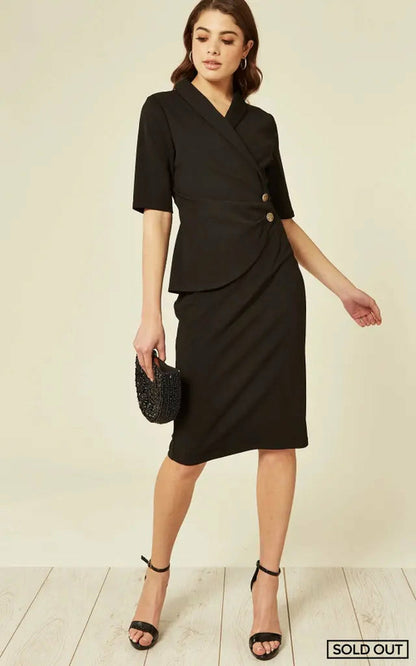 Black Diane Wrap Blazer Dress by Rose Eleusis, shown on a model, featuring a fitted blazer style with a wrap design and long sleeves.