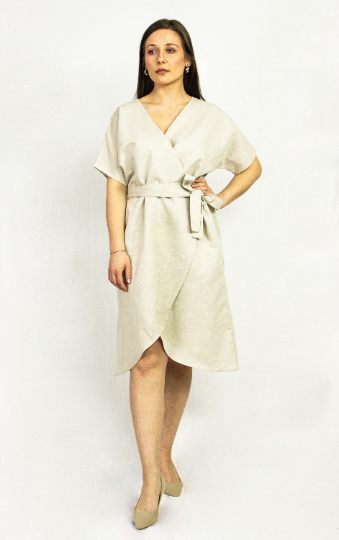 Natural Light linen wrap dress by Magenta Sugarplum, displayed on a hanger with a soft, flowing fabric and casual elegant style.