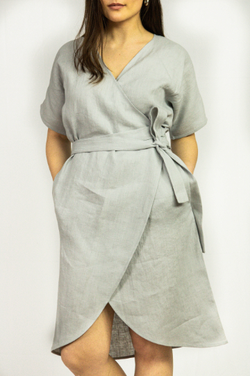 Natural Light linen wrap dress by Magenta Sugarplum displayed on a model, featuring a flowy silhouette and neutral tones.