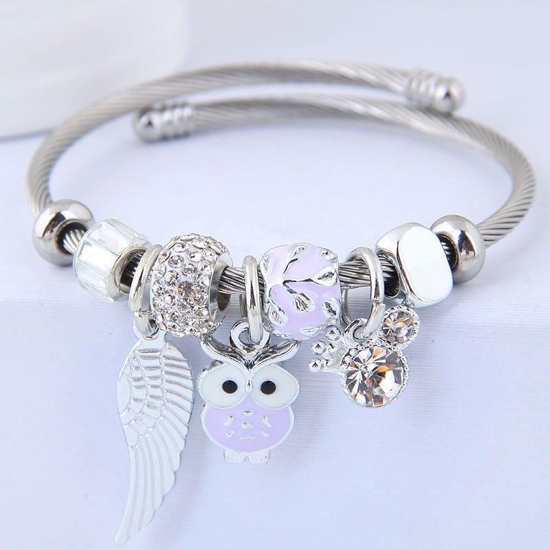 Beaded owl angel wings pendant bracelet by Carmine Medusa featuring stainless steel and intricate bead details.