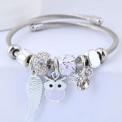 Beaded owl angel wings pendant bracelet by Carmine Medusa featuring stainless steel and intricate beadwork in a jewelry design.