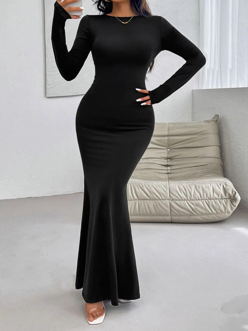 Ruby Styx Devine backless round neck long sleeve maxi dress worn by a woman, featuring a flowing silhouette and elegant style.