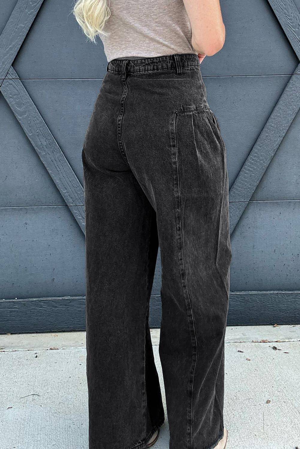 Dark grey pleated wide-leg denim pants by Carmine Juneberry featuring mineral wash finish and stylish, flowing design.