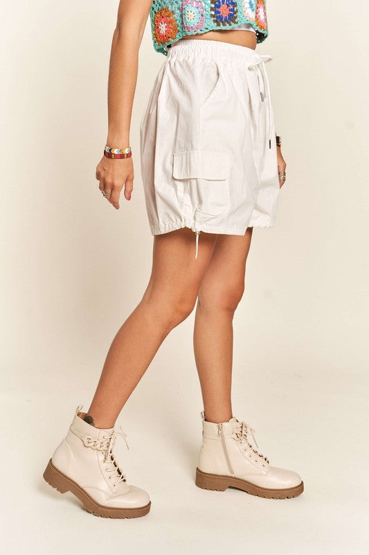 Jade Icarus ADORA drawstring shorts with pockets, featuring a casual automotive-inspired design, shown in the image.