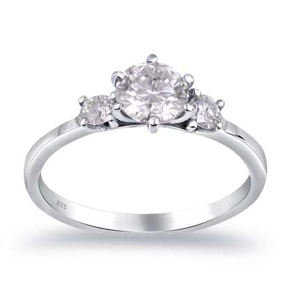 Sterling silver white moissanite 3-stone ring featuring sparkling gemstones and elegant design, crafted by Copper Juniper.