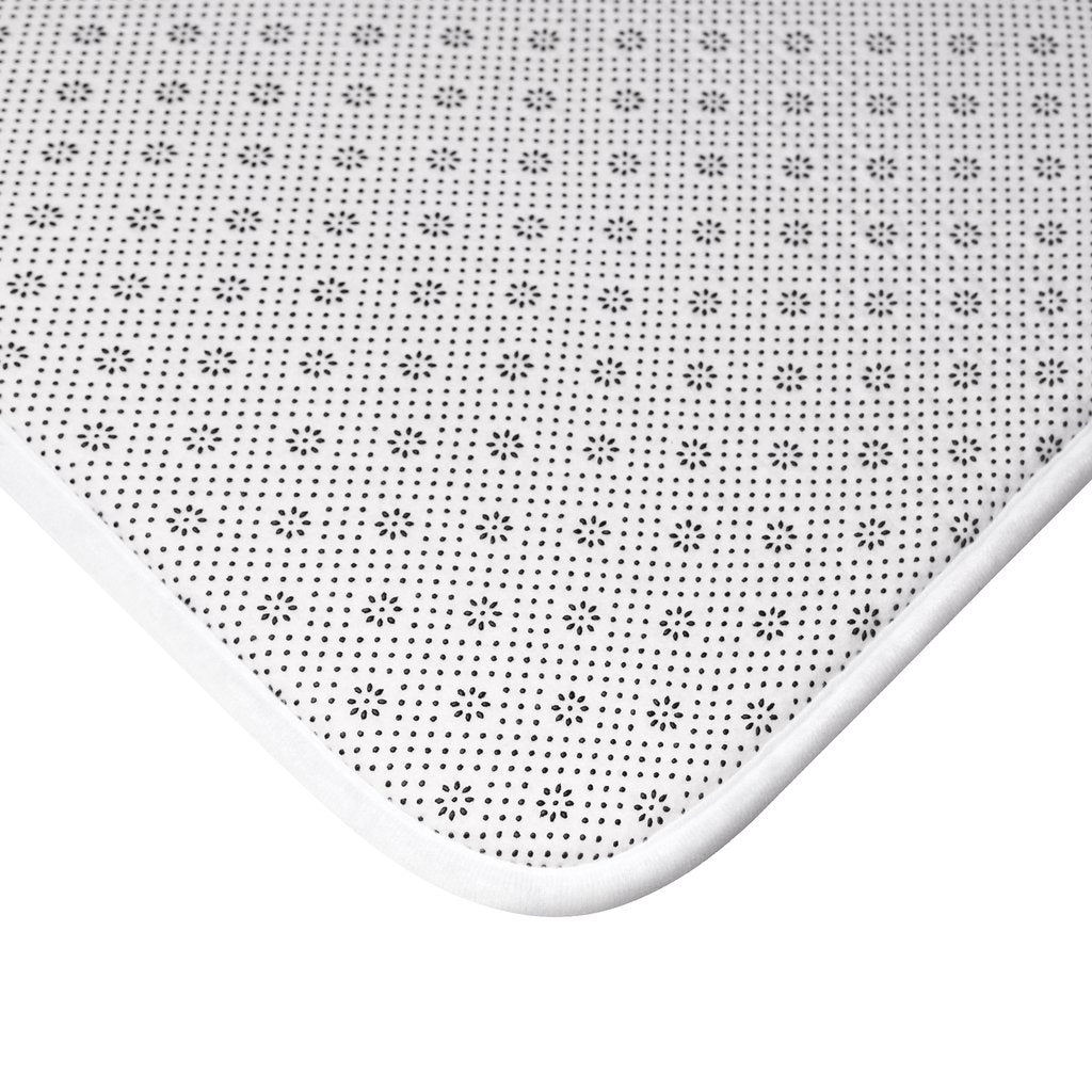 Yellow Pandora Waves bath mat with wavy textured design, placed on a bathroom floor for non-slip comfort and style.