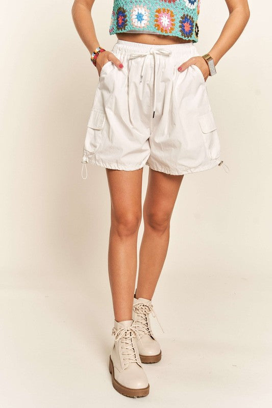Jade Icarus ADORA drawstring shorts with pockets, automotive-themed casual shorts, shown in navy blue fabric.