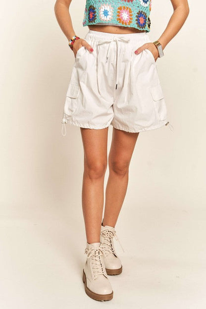 Jade Icarus ADORA drawstring shorts with pockets, automotive-themed casual shorts, shown in navy blue fabric.