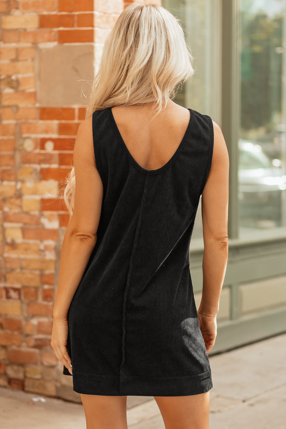 Byzantium Bay solid corduroy sleeveless mini dress with front pockets, stylish and comfortable for casual wear.