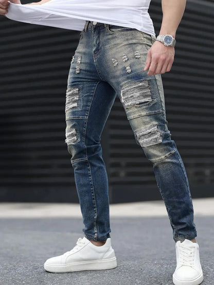 Men’s navy ripped stretch jeans by Carmine Juneberry, stylish high street denim with distressed details and a slim fit.