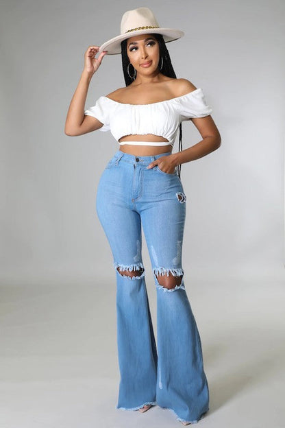 Jade Icarus Knee Rip Flare Jean in medium wash with 32-inch inseam, featuring distressed knees and classic denim style.