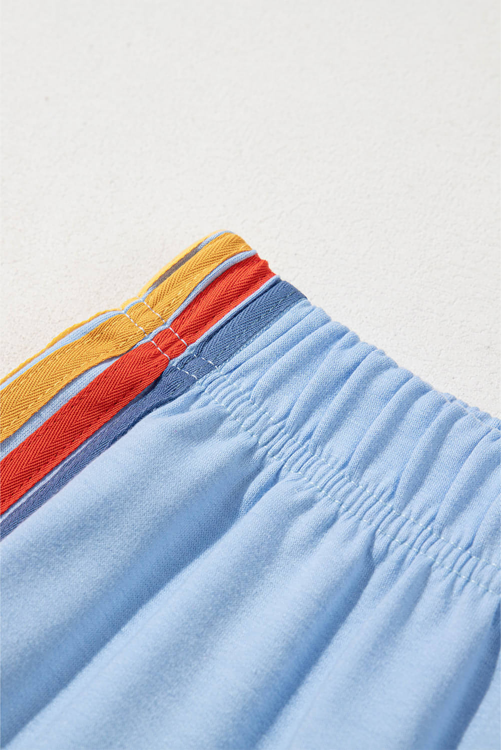 Light blue Carmine Juneberry high waist rainbows sweatpants with counting rainbow design, made from comfortable fabric.