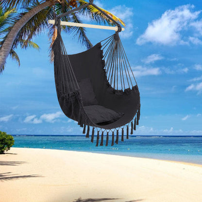 Gray LuneluX boho hanging chair with fringe and cushions, featuring a cozy, stylish furniture design by Carmine Juneberry.