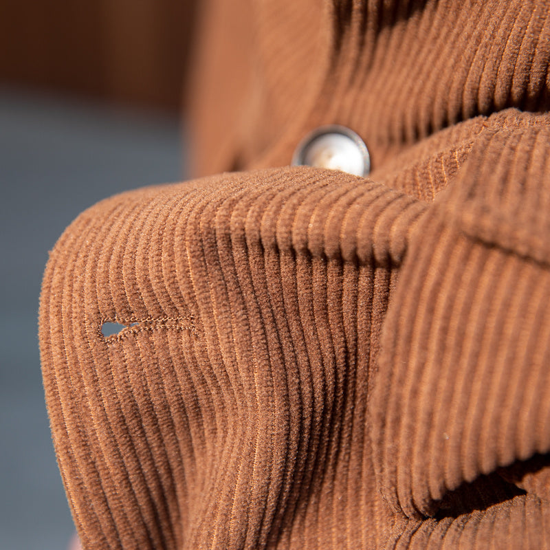 Carmine Juneberry Haute Edition 25 corduroy command jacket with classic collar and button-front design, shown on a hanger.