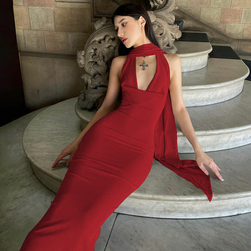 Green Alcestis slim backless halter neck dress, showcasing its elegant design and backless halter style in a fashion photograph.
