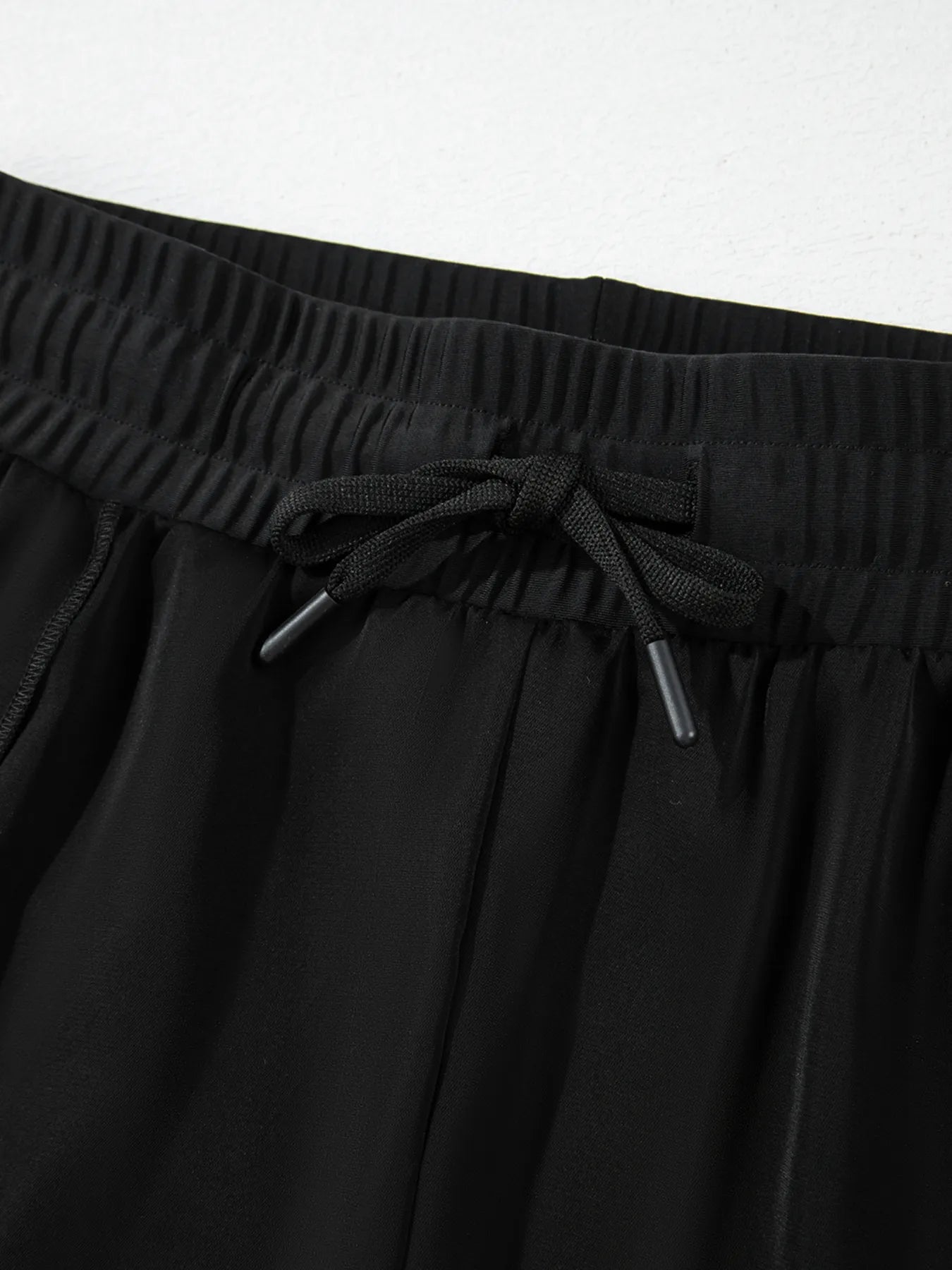 Pear Daisy high waisted drawstring swim shorts shown on a model, ideal for beach or poolside wear in a stylish design.