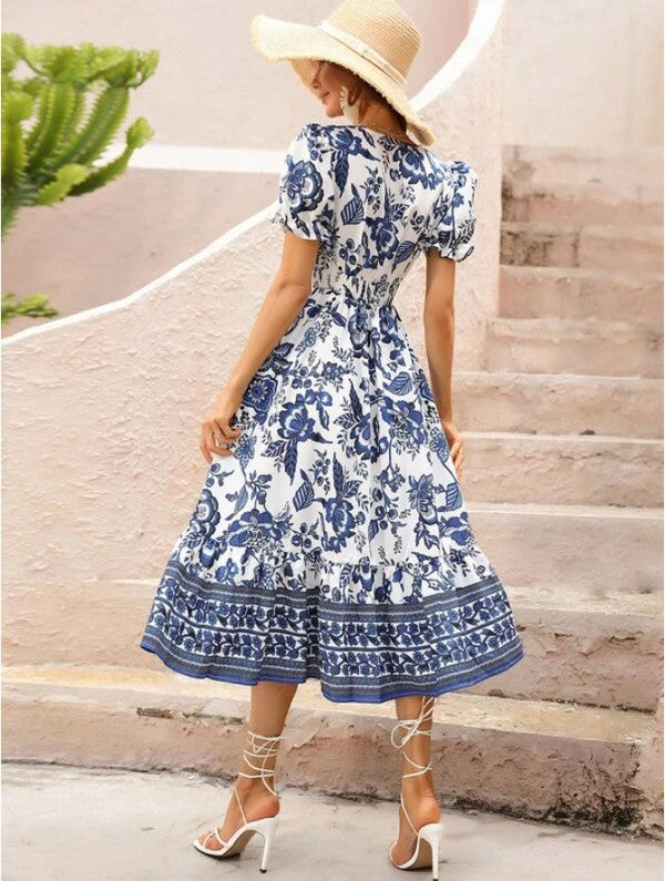 Women’s floral maxi dress with short sleeves and V-neck by Jade Icarus, featuring a vibrant floral pattern.