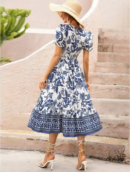 Women’s floral maxi dress with short sleeves and V-neck by Jade Icarus, featuring a vibrant floral pattern.