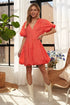Pear Daisy ADORA puff sleeve floral dress with a flowy design, displayed in a home setting with floral patterns and soft lighting.