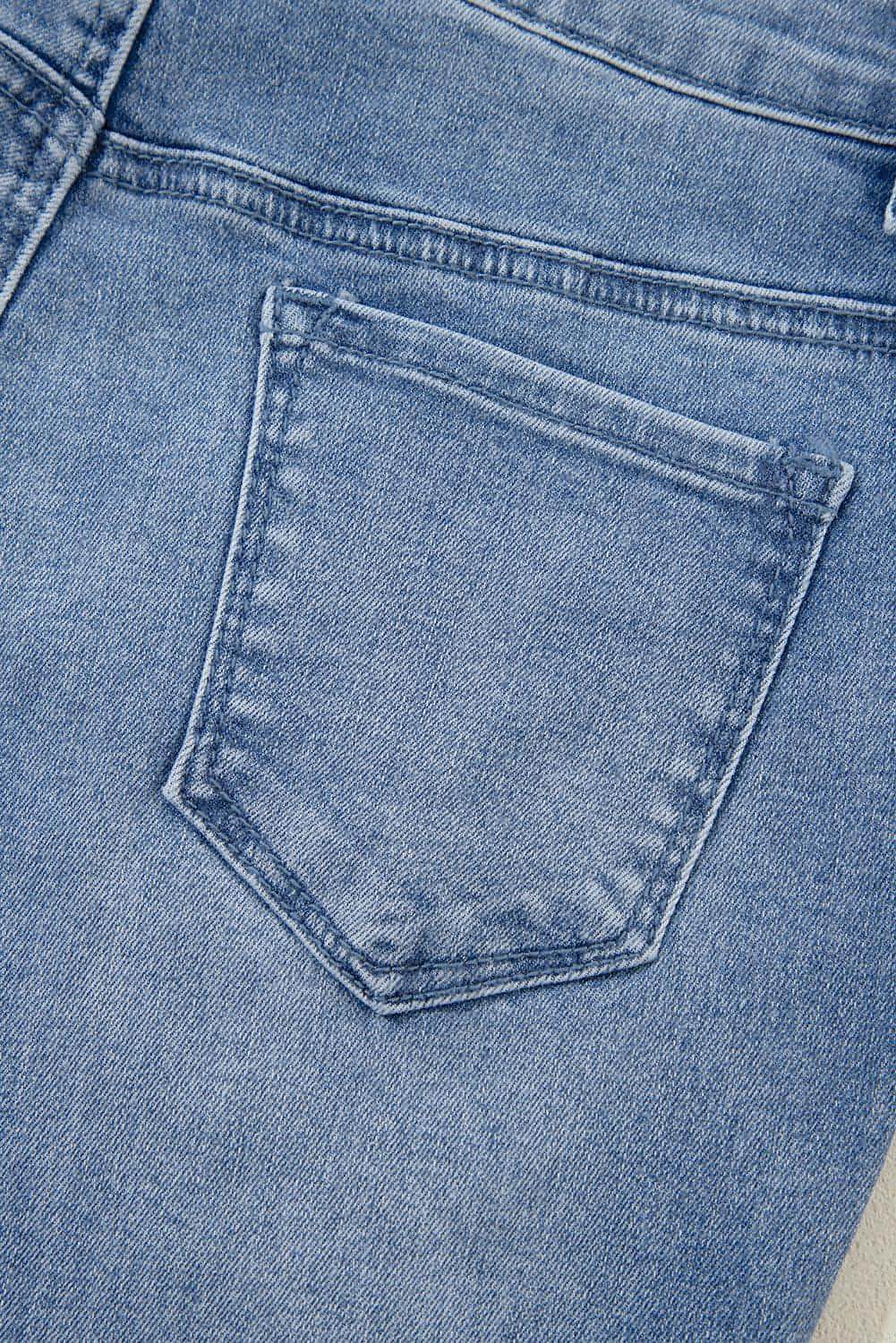 Blue acid wash distressed wide leg high waist jeans by Carmine Juneberry, featuring a relaxed fit and stylish distressed details.