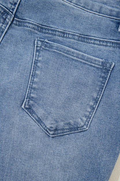 Blue acid wash distressed wide leg high waist jeans by Carmine Juneberry, featuring a relaxed fit and stylish distressed details.