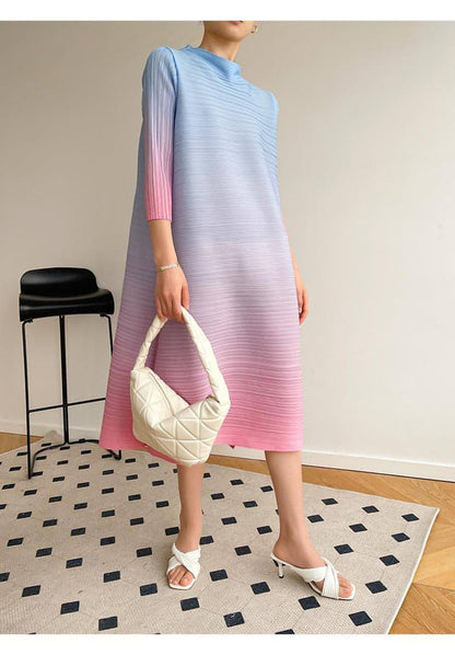 Plus size pleated dress for women by Carmine Juneberry, featuring a flowing, elegant design with a fitted waist and soft fabric.