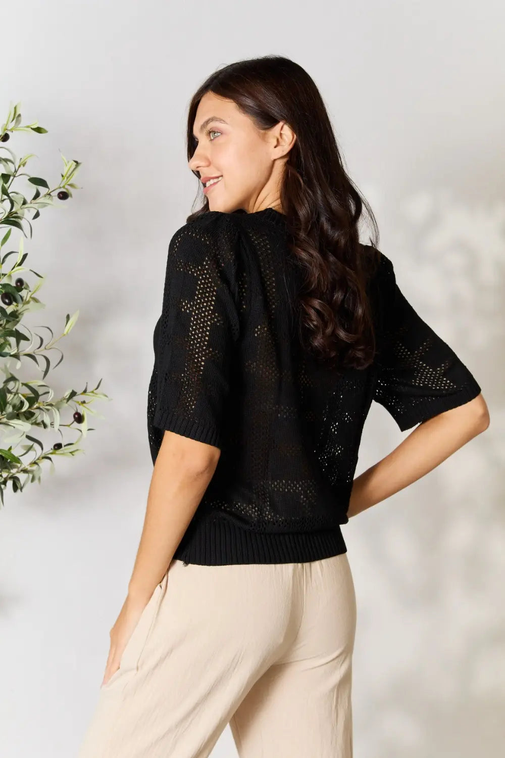 Pear Daisy Mandy ribbed trim round neck knit top, shown in cozy home setting, featuring a soft, ribbed fabric and classic round neckline.