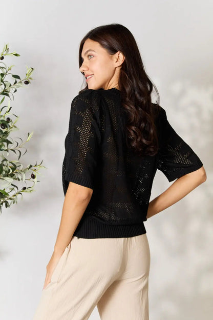 Pear Daisy Mandy ribbed trim round neck knit top, shown in cozy home setting, featuring a soft, ribbed fabric and classic round neckline.