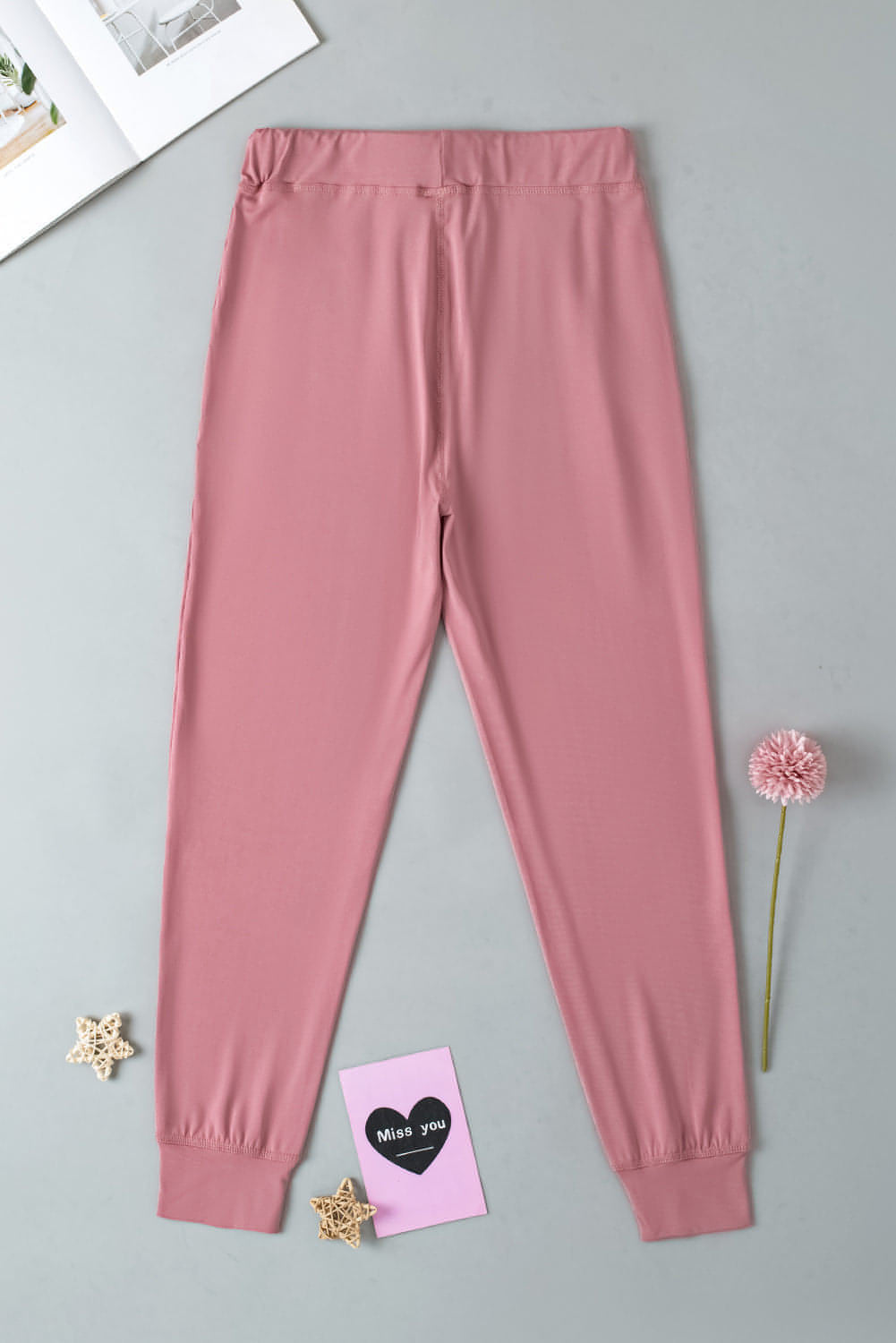 Pink drawstring waist joggers with pockets, designed for activewear by Carmine Juneberry, shown in a casual, comfortable fit.
