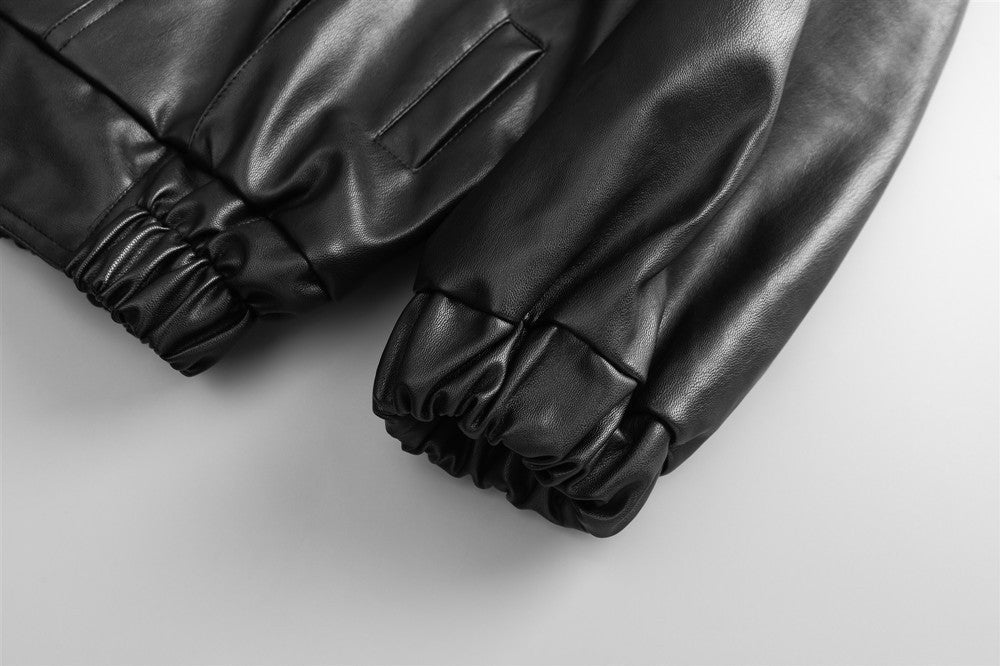 Black Drive Moto Jacket by Carmine Juneberry featuring a sleek, fitted design with metallic zipper details and quilted accents.