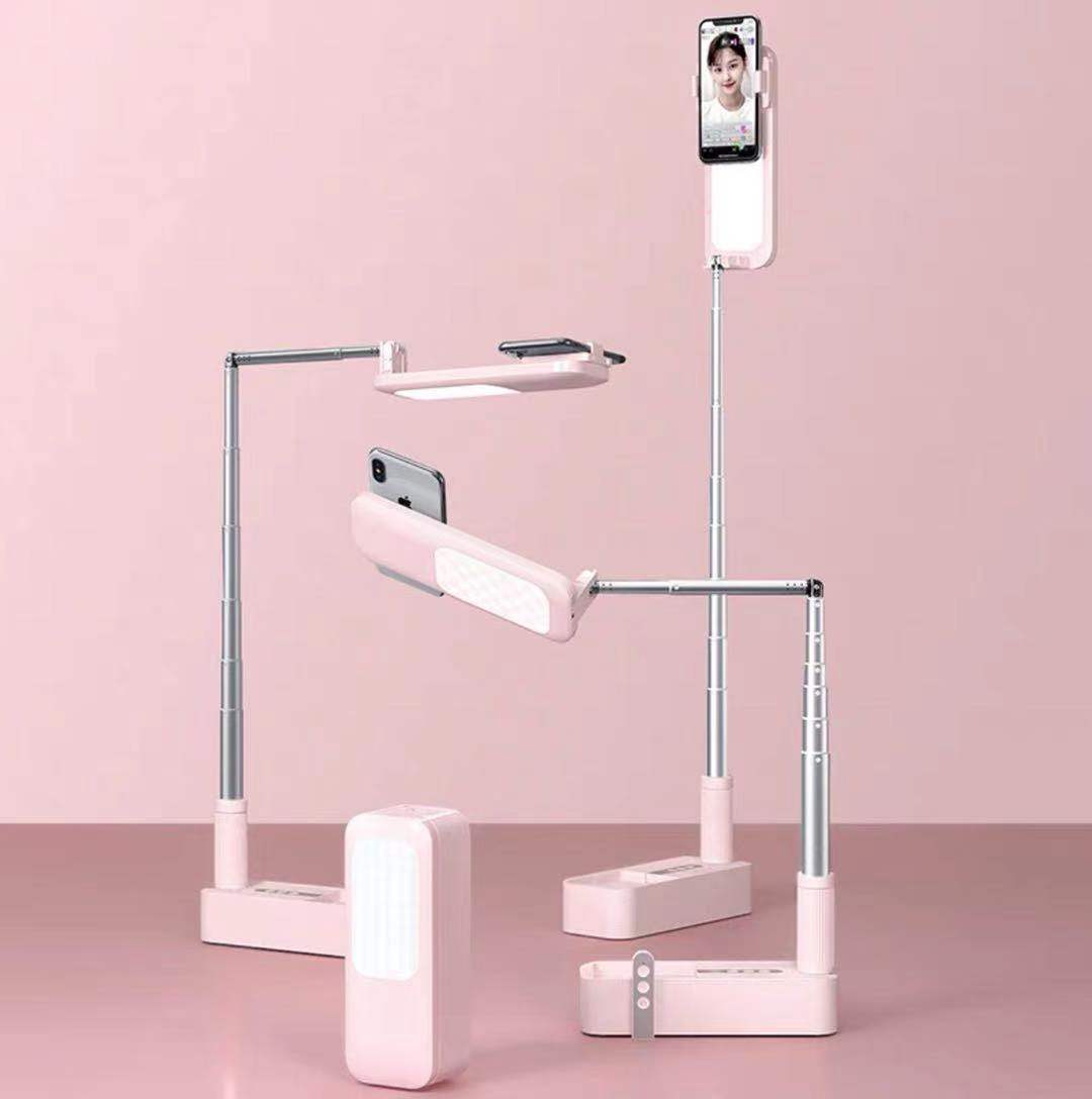Maroon Asteria selfie portable phone holder with built-in light, ideal for mobile and laptop use, shown with phone in the image