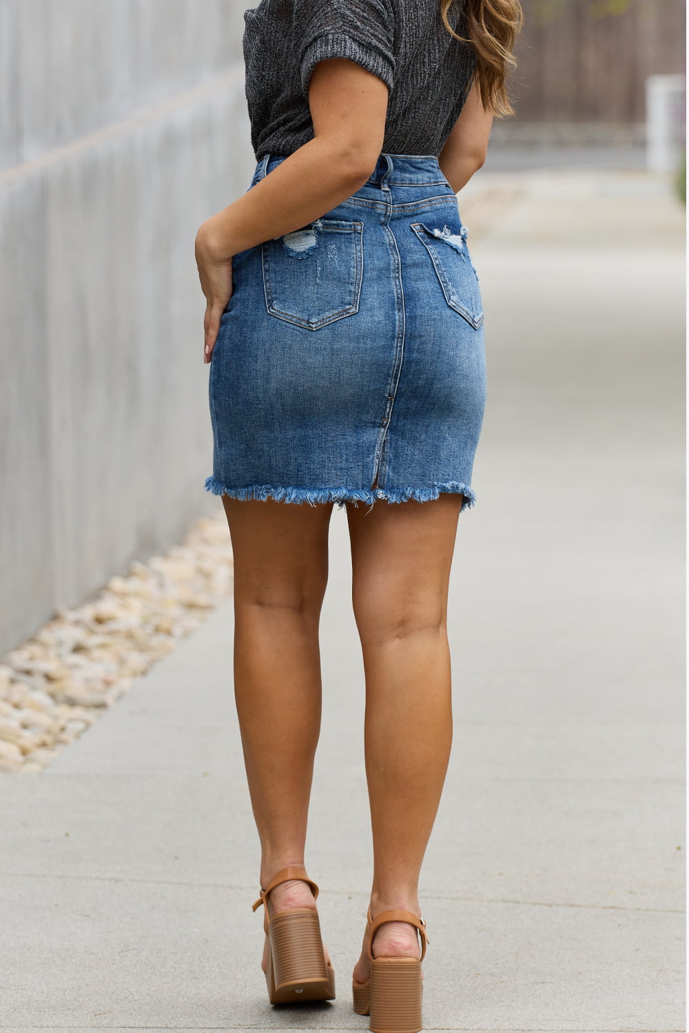 Full size denim mini skirt by Jade Icarus, styled with automotive-inspired design elements, displayed on a mannequin.