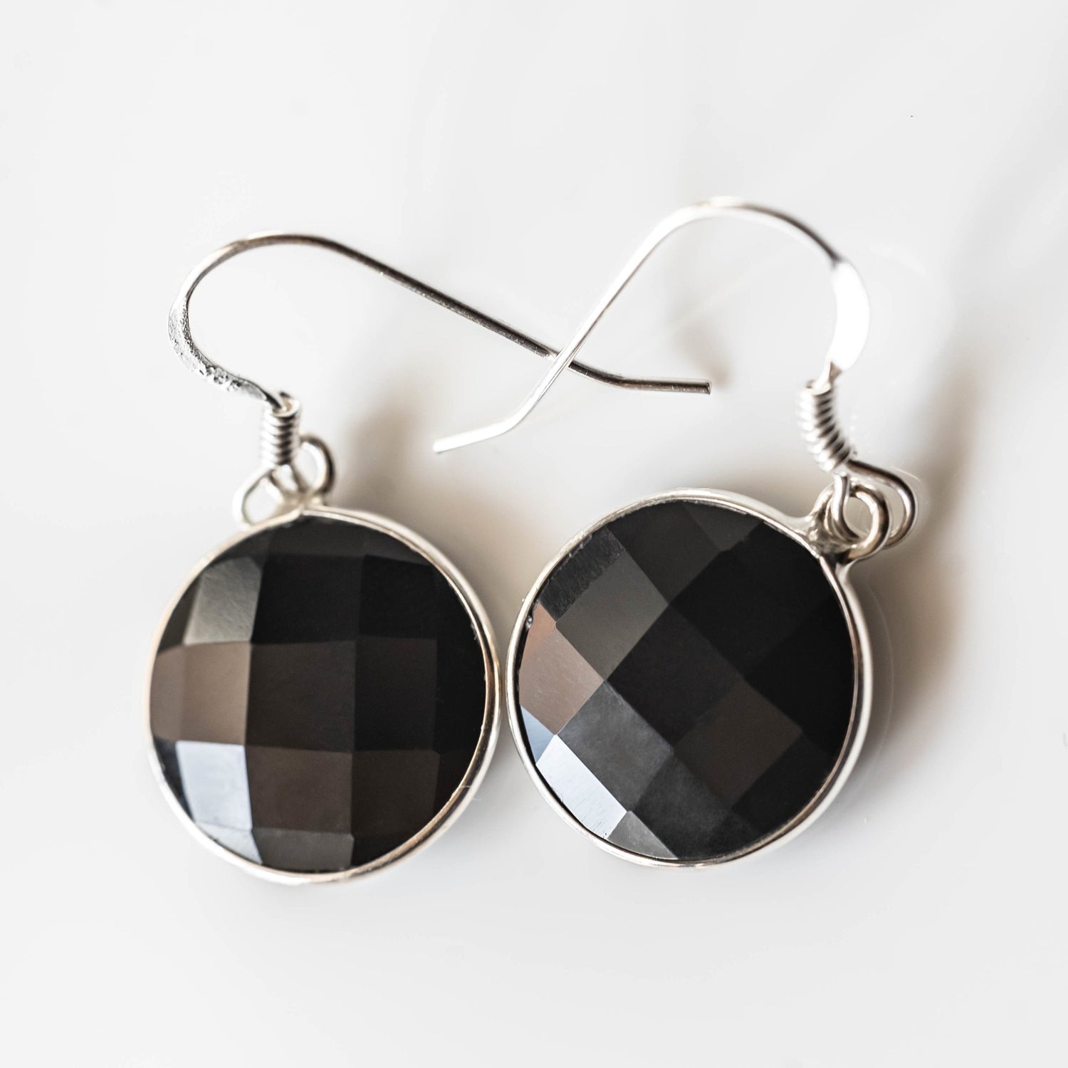 Elegant Emily Black Onyx round drop earrings by Sapphire Maple featuring polished black onyx stones and sleek gold settings.
