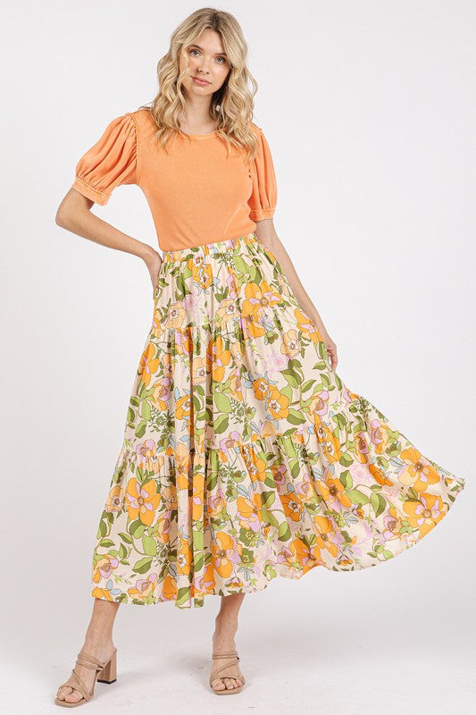 Colorful flower print elastic waist tiered skirt by Jade Icarus, showcasing a flowing fabric and vibrant floral pattern.