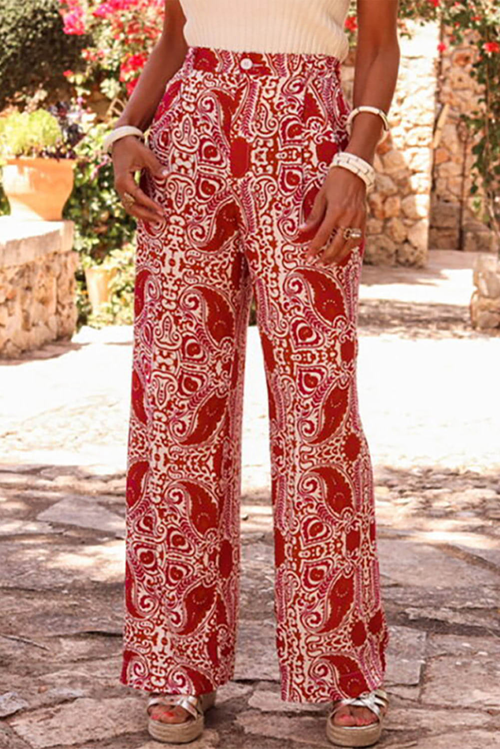Red paisley printed high waist straight-leg pants by Carmine Juneberry, featuring button details and a stylish, comfortable fit.