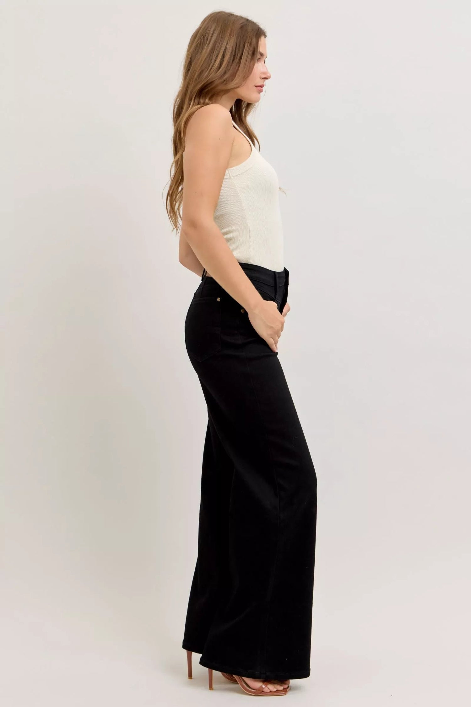 Pear Daisy Judy Blue high-waisted wide leg jeans for women, displayed on a hanger with a casual home setting background.