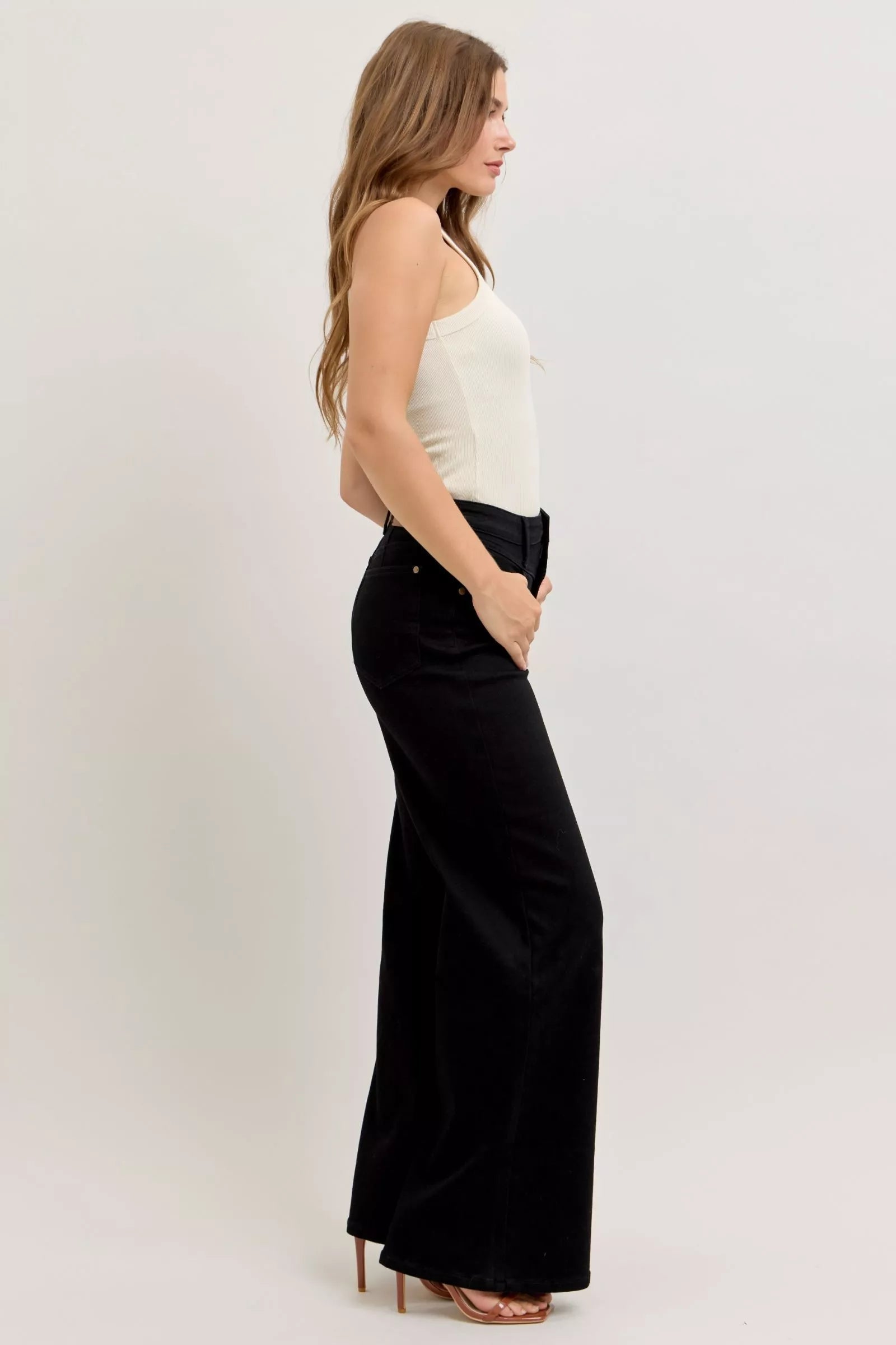 Pear Daisy Judy Blue high-waisted wide leg jeans for women, displayed on a hanger with a casual home setting background.