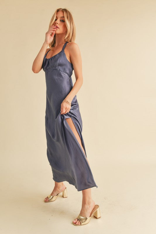 Jade Icarus Aemi + Co maxi cami dress with ruched side slit and cutout back, displayed on a hanger against a white background.