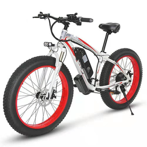 Carmine Juneberry Forever™ E-Glide Snow 26 electric mountain bike with 21-speed gears and 350W motor on rugged trail.