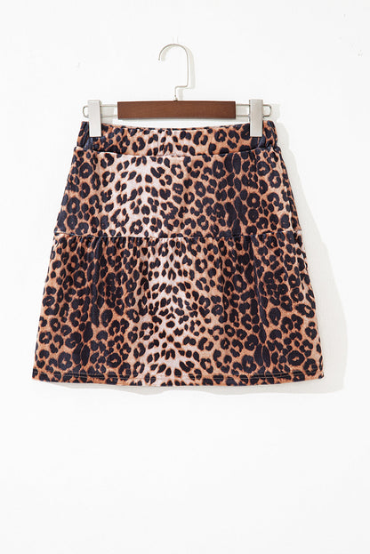 Leopard tiered patchwork mini skirt by Byzantium Bay featuring layered fabric and bold animal print design.
