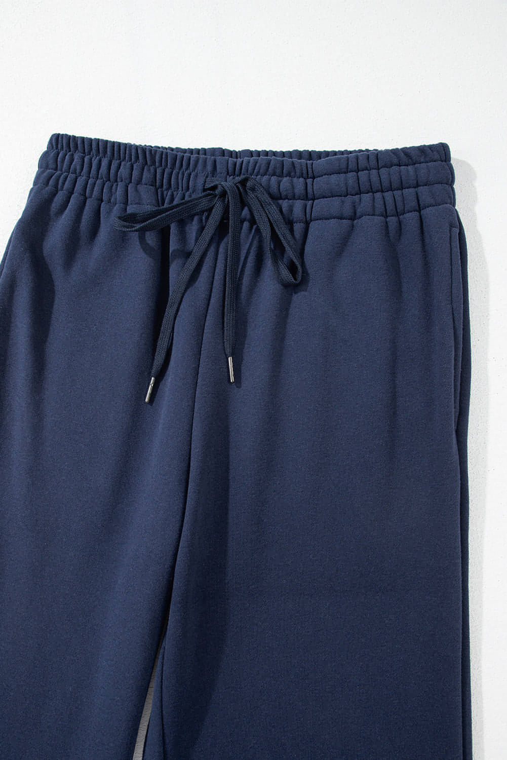 Navy blue fleece-lined casual pants with drawstring waist from Carmine Juneberry, comfortable and stylish for everyday wear.