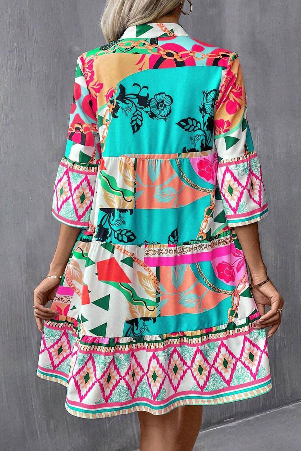 Multicolour abstract printed half sleeve mini dress with notched neckline by Carmine Juneberry, stylish and vibrant for casual wear.