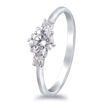 White moissanite 3-stone sterling silver ring featuring sparkling gemstones, elegant jewelry piece with a sleek band design.