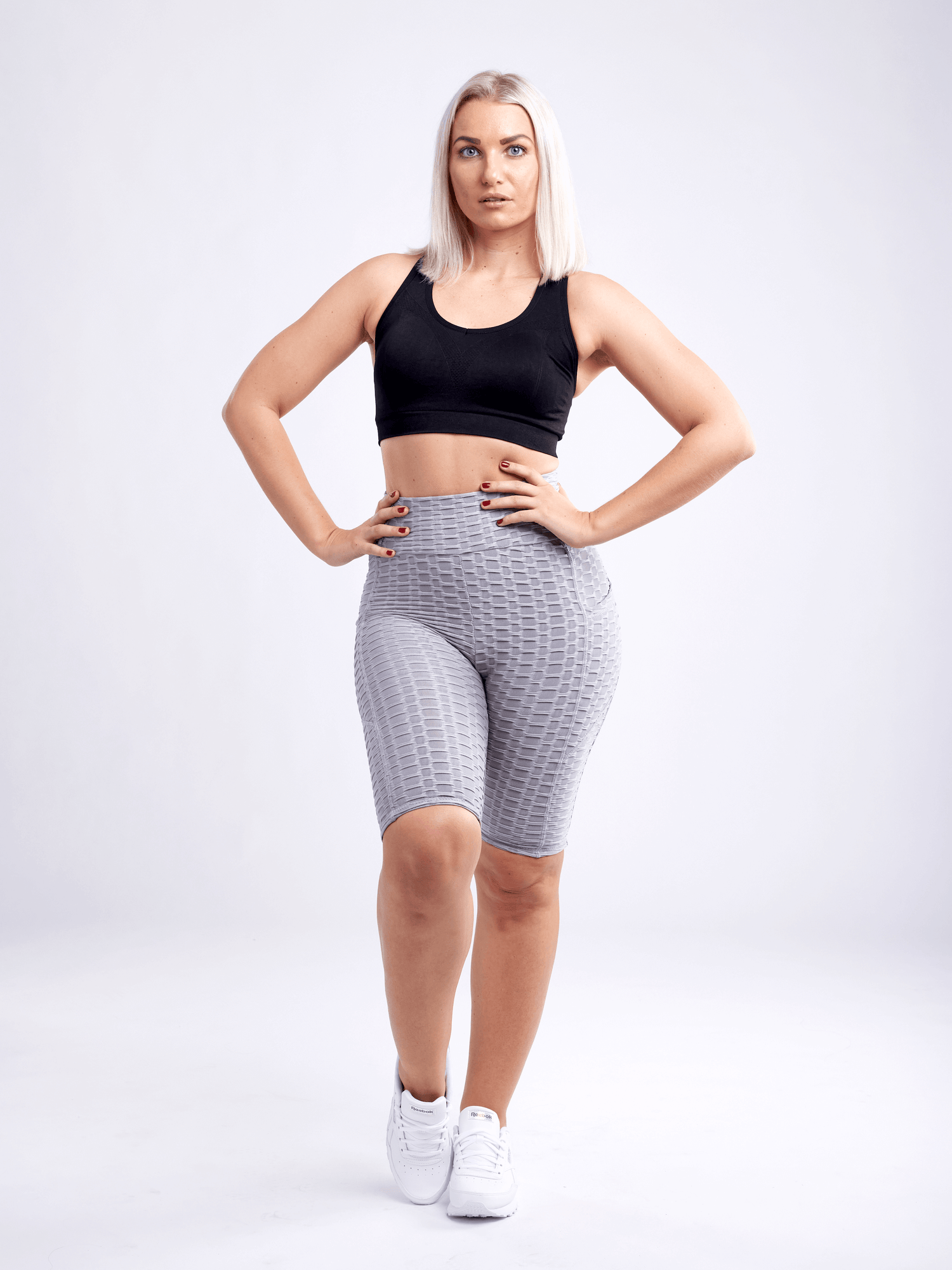 Black Lavender JupiterGear high-waisted scrunch yoga shorts with hip pockets, shown on a model, emphasizing fit and activewear design.
